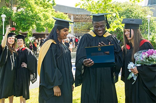 Photo of ELC students on graduation day wearing their cap and gown.
