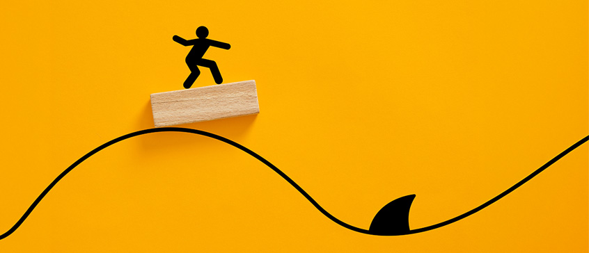 Line drawing of a surfer at the top of the wave and the bottom has a shark