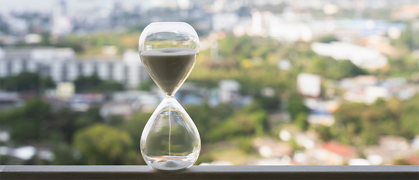 Sand hourglass stilling on windowsill 