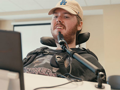 Collection of accessibility icons including wheelchair symbol, sign language hands, walking figure, ear for hearing, brain for cognitive accessibility, and eye for visual impairment, representing diverse workplace accommodations and inclusive design