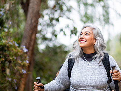 Woman on a hike enjoying the forest.