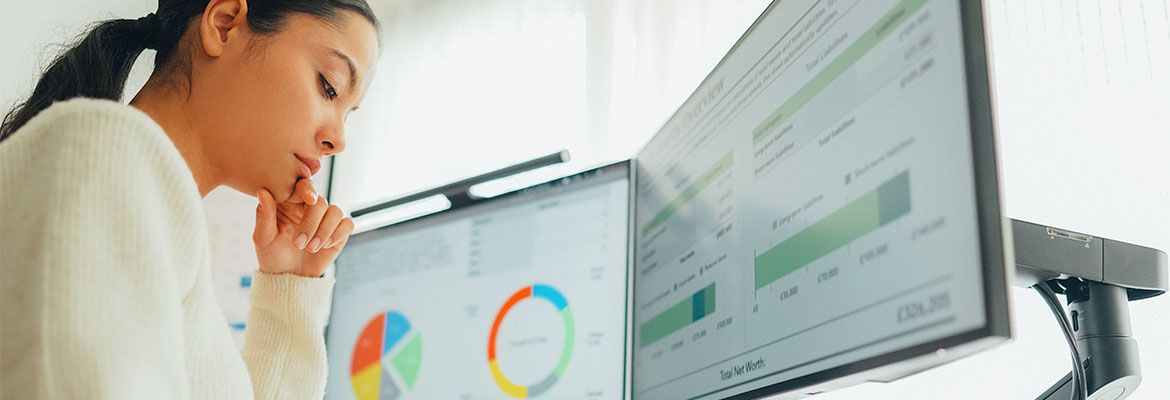 Woman with graphs and charts open on computer display