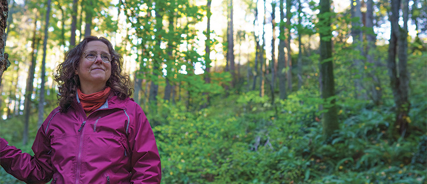 Photo of Dr. Kara Shaw in a beautiful BC forest. 