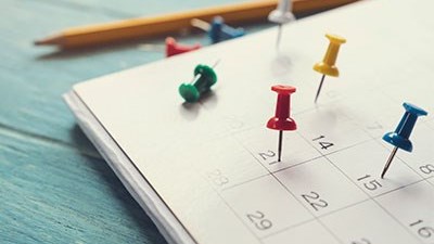 A calendar with pins