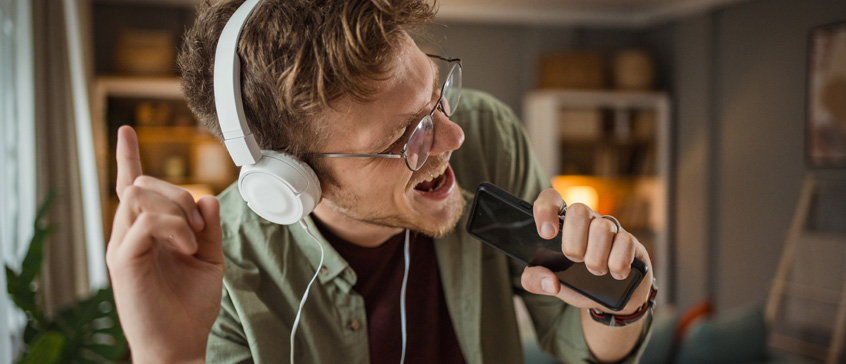 Man singing with headphones on.