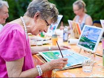 Photo of a woman painting with friends