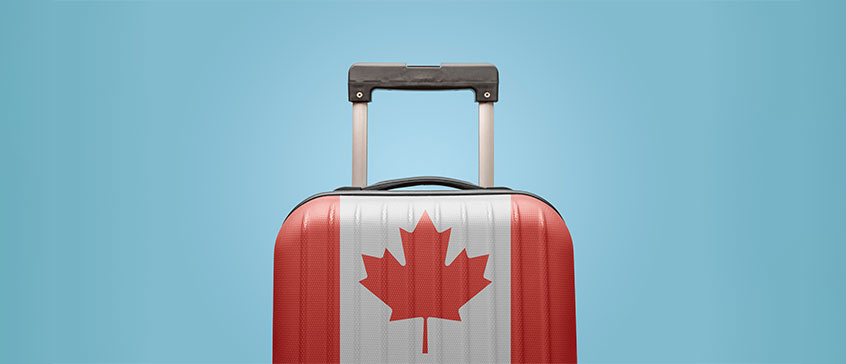 Image of a suitcase with a Canadian flag on it. 