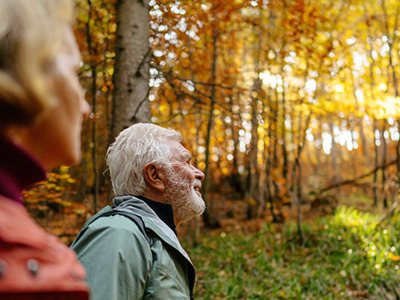 Seniors going for a walk in the forest. 