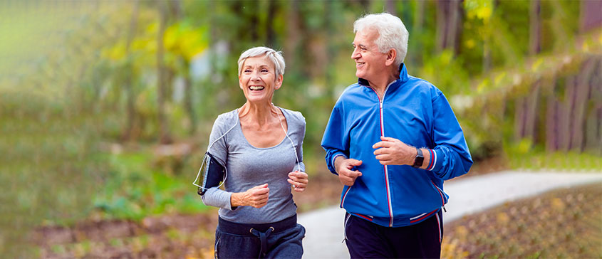 Photo of fit seniors jogging outdoors. 