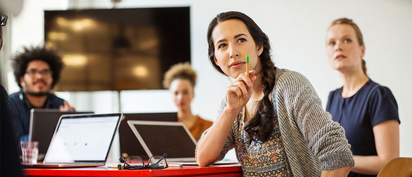 Picture of woman concentrating during a team meeting.