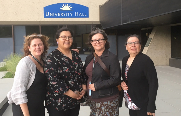Photo of four people at Stabilizing Indigenous Languages Symposium 