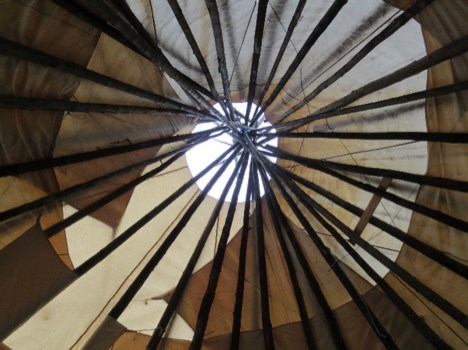 Photo looking up at the inside of a tipi