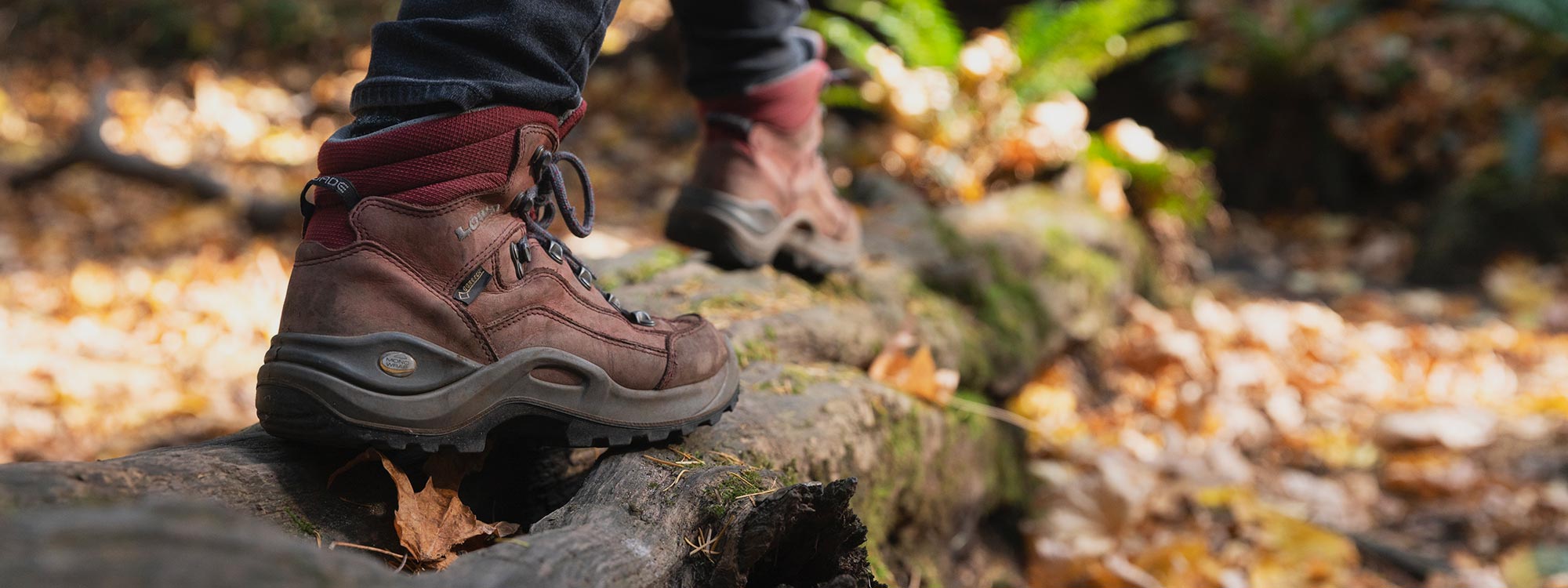 Close-up boots walking along forest log