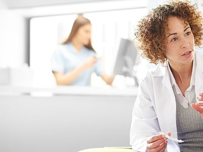 photo of pharmacist talking with elderly patient